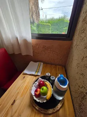 a table with a cake with fruit on it at Hospedaje Del Rosario in Santa María
