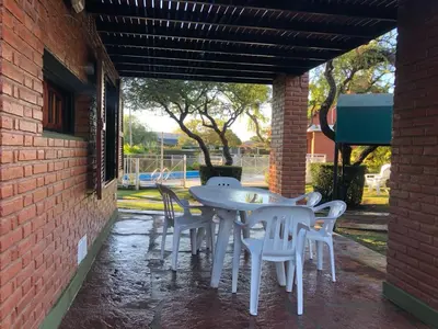 a white table and chairs on a patio at Cabaña Los Estribos 1 in Merlo