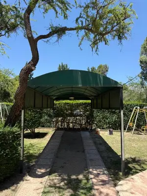 a pavilion in a park with a tree at Cabaña Los Estribos 1 in Merlo