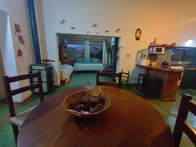 a living room with a wooden table and a couch at El Mirador de Ana Villa de las Rosas in Villa de Las Rosas
