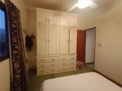 a bedroom with a white dresser and a large cabinet at El Mirador de Ana Villa de las Rosas in Villa de Las Rosas