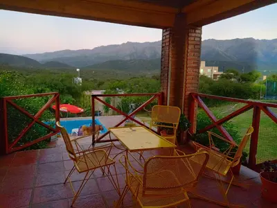 a table and chairs on a patio with a view at El Mirador de Ana Villa de las Rosas in Villa de Las Rosas