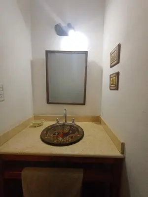 a bathroom with a sink and a mirror on a counter at El Mirador de Ana Villa de las Rosas in Villa de Las Rosas