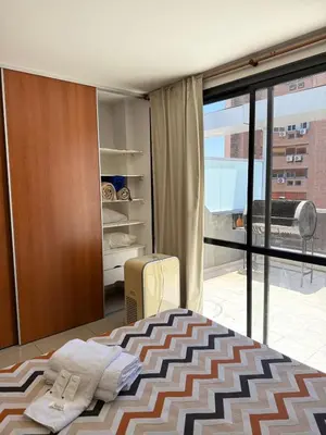 a bedroom with a bed and a sliding glass door at Dúplex con balcón en Nueva Córdoba by Lofty in Cordoba