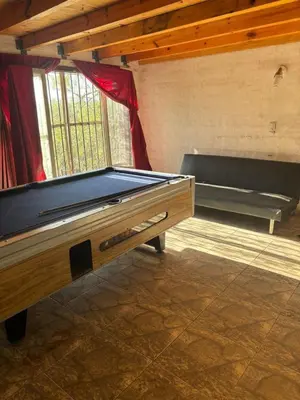 a room with a pool table and a bench at Refugio de Nestor in Villa Parque Siquiman