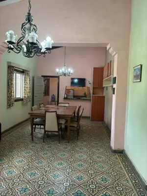 a kitchen and dining room with a table and chairs at Refugio de Nestor in Villa Parque Siquiman