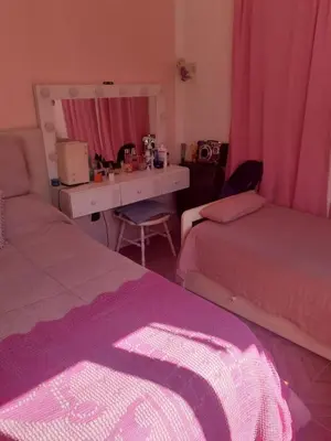 a bedroom with two beds and a desk with a mirror at lo de carla in Villa Carlos Paz