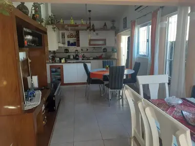a kitchen and dining room with a table and chairs at lo de carla in Villa Carlos Paz