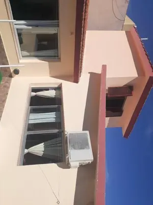a building with a window with a laptop on it at lo de carla in Villa Carlos Paz