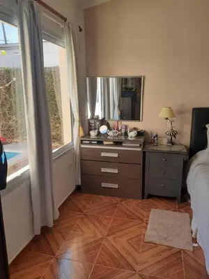 a bedroom with a bed and a dresser and a mirror at lo de carla in Villa Carlos Paz
