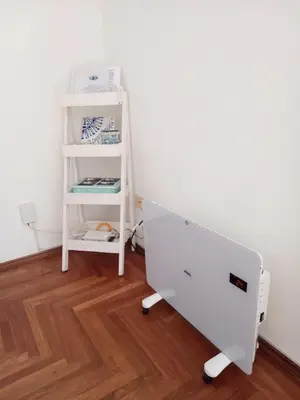 a white bed in a room with a shelf at El Sol de Vilaró Dpto a mts de todo in Cordoba