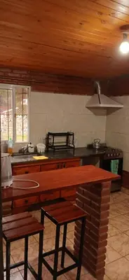 a kitchen with a stove and a counter top at Las tres lunas in Villa Anizacate
