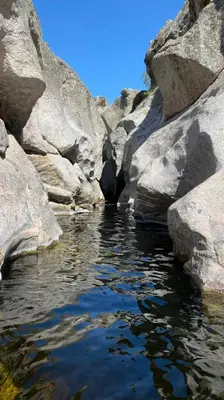 a pool of water with rocks in a river at Adlerhaus in La Cumbrecita