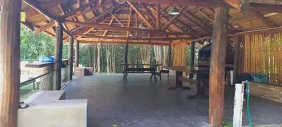 a large wooden pavilion with a table in the middle at Tinkunaco Merlo in Merlo