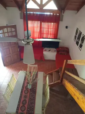 a view of a living room with a red couch at Tinkunaco Merlo in Merlo