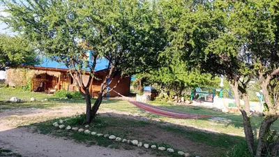 a hammock hanging between two trees in a yard at Cabaña 1 in Arroyo de Los Patos