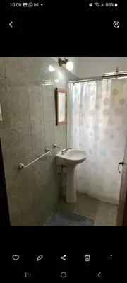 a bathroom with a sink and a shower with a shower curtain at Elrincondemaximo in Santa Rosa de Calamuchita