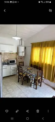 a kitchen with a table and chairs in a kitchen at Elrincondemaximo in Santa Rosa de Calamuchita