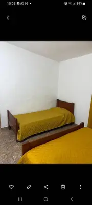 two beds in a room with yellow sheets at Elrincondemaximo in Santa Rosa de Calamuchita