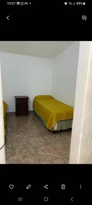 a bedroom with a bed and a table in a room at Elrincondemaximo in Santa Rosa de Calamuchita