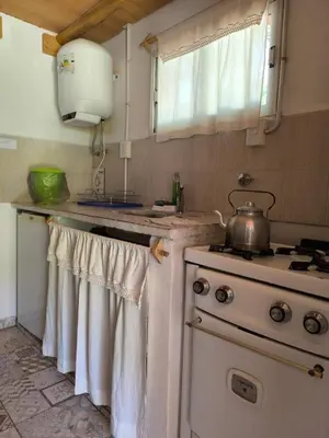 a kitchen with a stove and a pot on the counter at Aimara Casas de alquiler in Mina Clavero