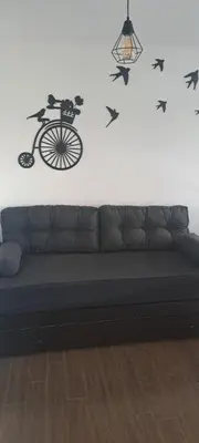 a room with a couch and a wall with a bike and bats at Santino in Cordoba