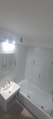 a white bathroom with a sink and a shower at Santino in Cordoba