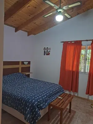 a bedroom with a bed and a wooden ceiling at Sol y Luna in Barrio Parque El Corcovado