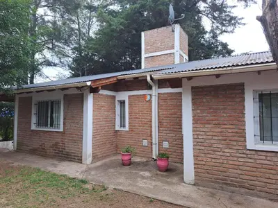 a brick house with two potted plants in front of it at Sol y Luna in Barrio Parque El Corcovado