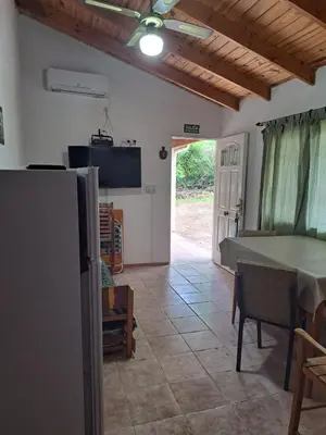 a living room with a table and a tv at Sol y Luna in Barrio Parque El Corcovado