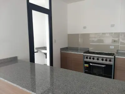 a kitchen with a stove and a counter top at Departamento centro Carlos Paz in Villa Carlos Paz