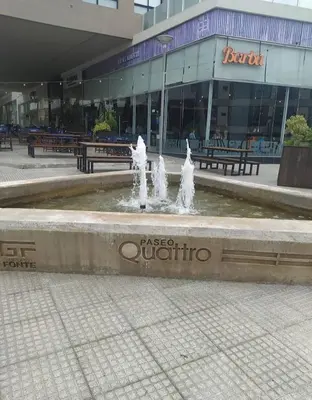 a fountain with two fountains in front of a building at Departamento centro Carlos Paz in Villa Carlos Paz