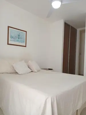 a white bed with two white pillows on it at Departamento centro Carlos Paz in Villa Carlos Paz