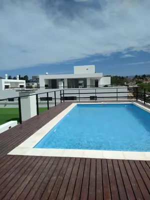a swimming pool on the deck of a house at Departamento centro Carlos Paz in Villa Carlos Paz