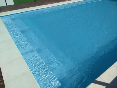 a blue swimming pool with water in it at Departamento centro Carlos Paz in Villa Carlos Paz