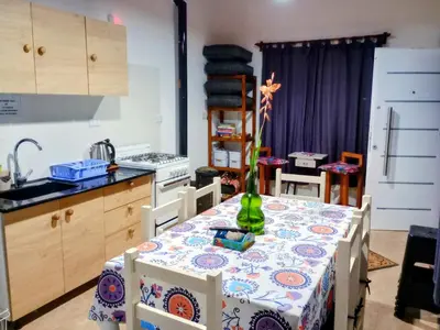 a kitchen with a table with a vase on it at Elmosquetal in Villa Yacanto