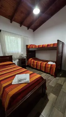 a bedroom with two beds and a window at Cabañas Los Molles in Arroyo de Los Patos