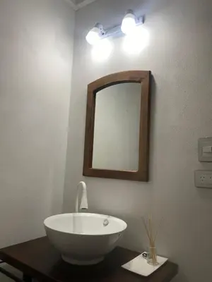 a bathroom with a white sink and a mirror at Cabañas Los Molles in Arroyo de Los Patos