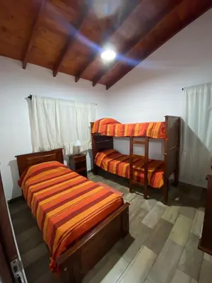 a bedroom with two bunk beds and a ceiling at Cabañas Los Molles in Arroyo de Los Patos