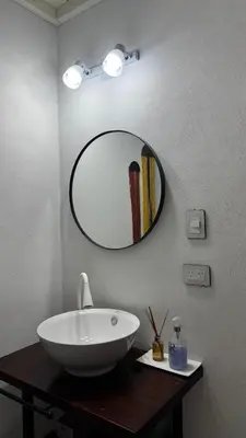 a bathroom with a white sink and a mirror at Cabañas Los Molles in Arroyo de Los Patos