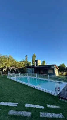 a swimming pool in front of a building at Cabañas Los Molles in Arroyo de Los Patos