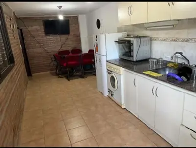 a kitchen with a refrigerator and a counter top at Casa interna en Playas de Oro Carlos Paz in Villa Carlos Paz