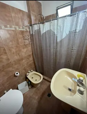 a bathroom with a sink and a toilet and a shower at Casa interna en Playas de Oro Carlos Paz in Villa Carlos Paz