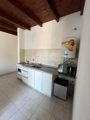 a kitchen with a sink and a counter top at Complejo Joaquina in Río Cuarto