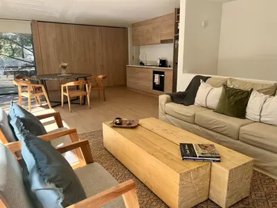 a living room with a couch and a coffee table at Casa entre pinos in La Florida