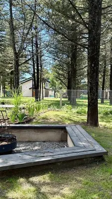 a park with a bench and trees in a field at Casa entre pinos in La Florida
