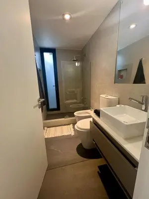 a bathroom with a sink and a toilet and a mirror at Casa entre pinos in La Florida