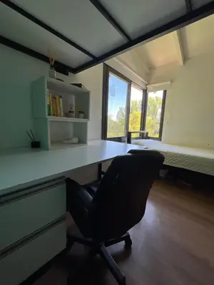 a office with a desk and a chair in a room at casa junto al rio para 7 in Villa Carlos Paz