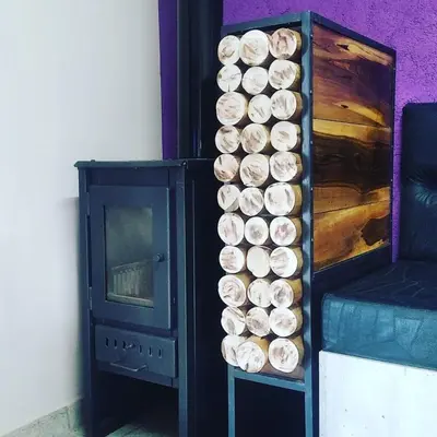 a bunch of wooden barrels are lined up next to a fireplace at Aires de Montaña cabañas in La Estancia