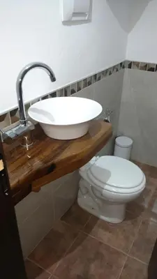 a bathroom with a sink and a toilet at Aires de Montaña cabañas in La Estancia